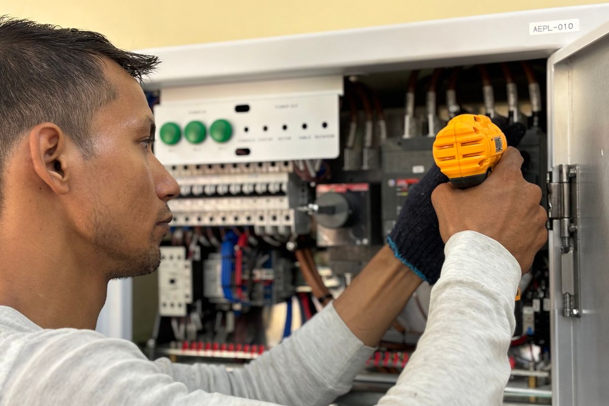 Electrician at work on a home electrical panel