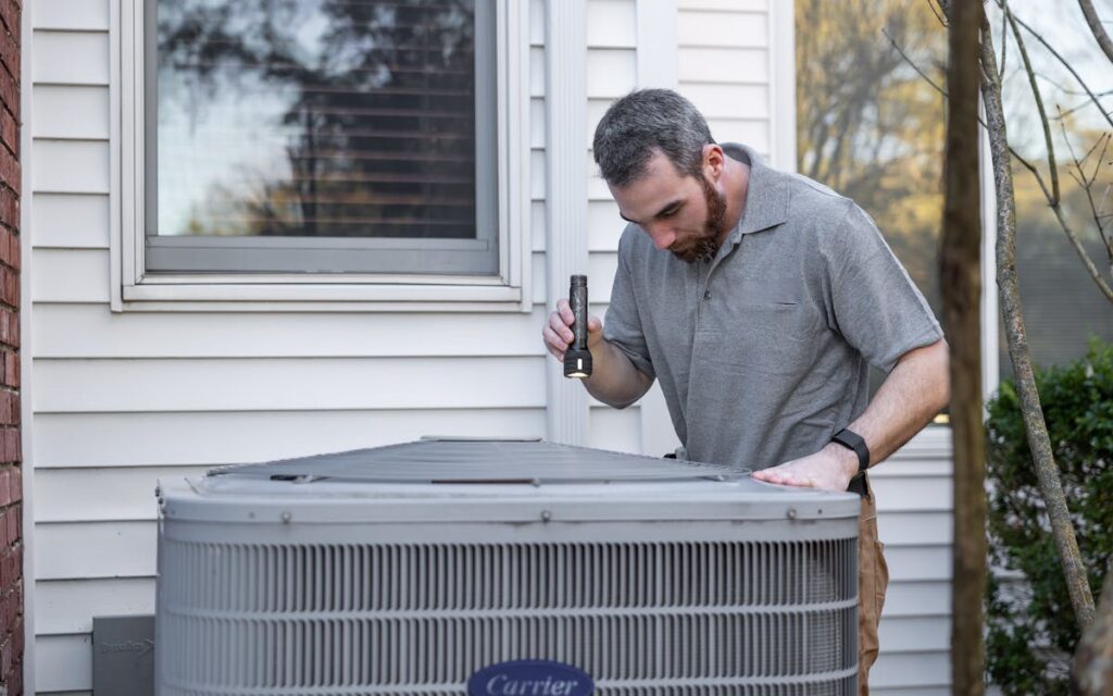 HVAC technician inspecting an outdoor unit, illustrating HVAC marketing in Parsippany NJ