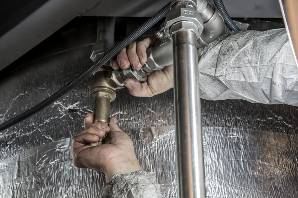 Plumber marketing in Rockaway NJ, a professional plumber installing pipe fittings