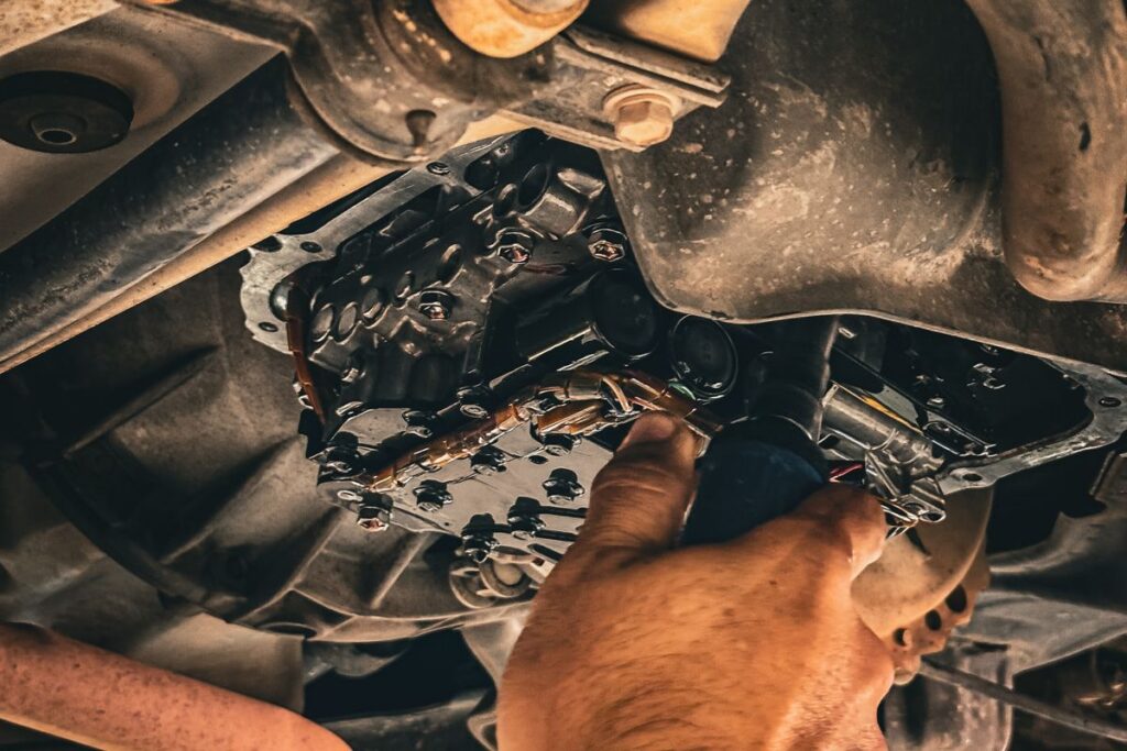 Auto repair shop marketing in Butler NJ, mechanic performing a repair under a vehicle in a garage