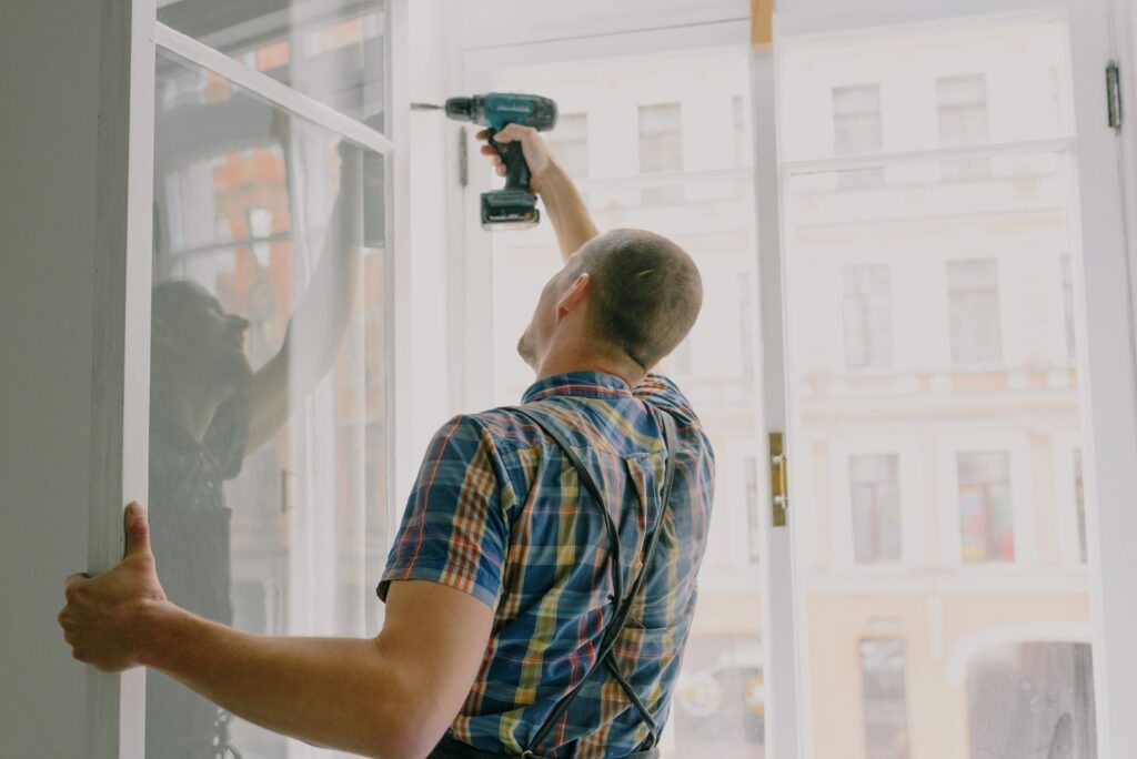 Window company installer fitting a new home window, window company marketing in Pequannock NJ