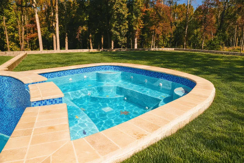 Close view of the spa steps and tile band on an Elite Paradise pool in Morganville NJ