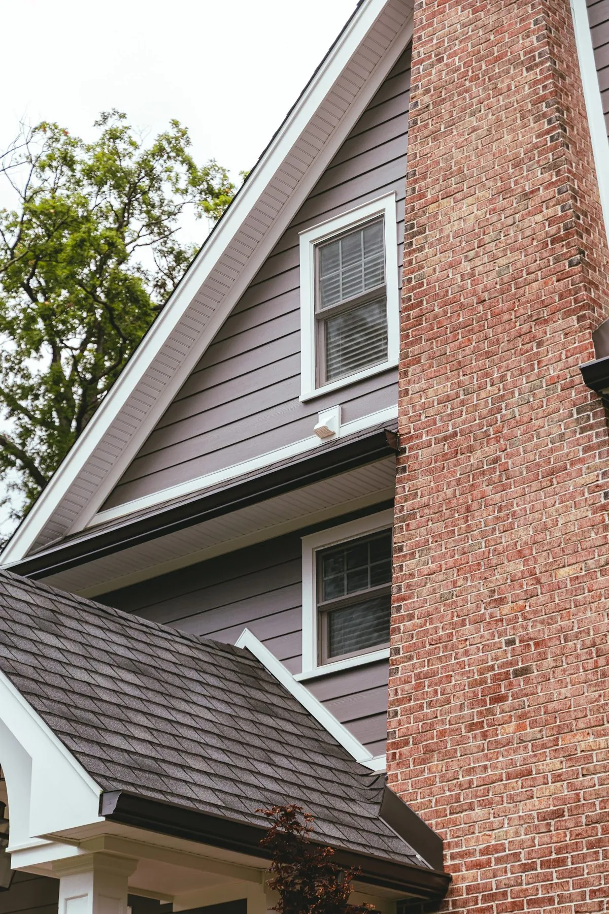 Brick chimney, shingle roofline and gutter on a North Jersey home photographed by The Hype Hero