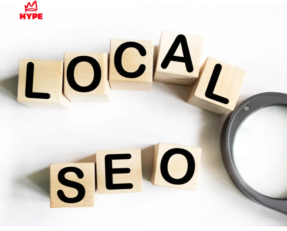 Local SEO letter blocks with a magnifying glass, SEO services by The Hype Hero